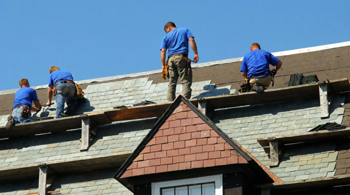Roof replacement in progress with a team of professional contractors installing new shingles on a residential home in Glendale, AZ