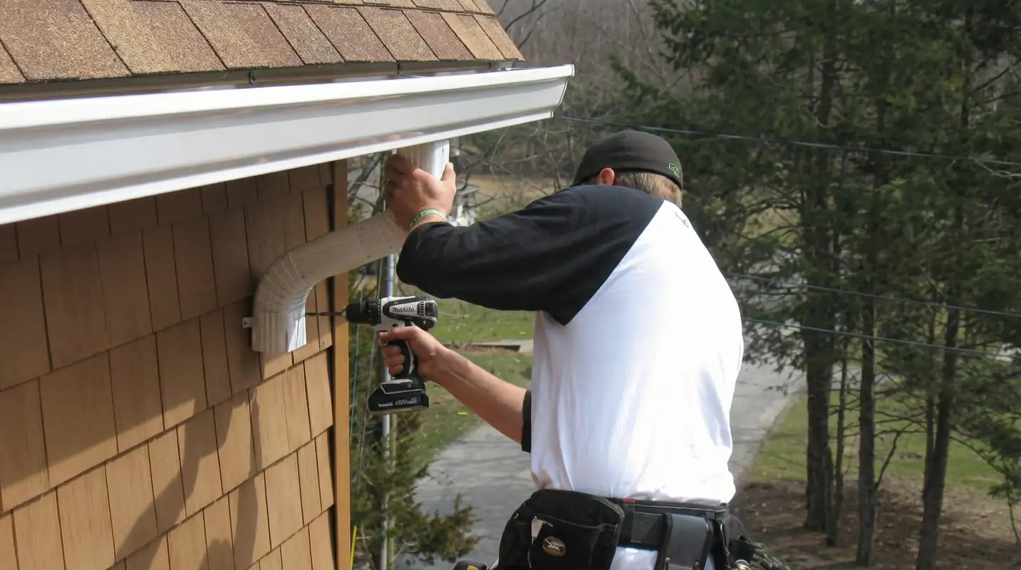 Professional contractor installing tan vinyl siding panels on a residential home exterior in Glendale, AZ